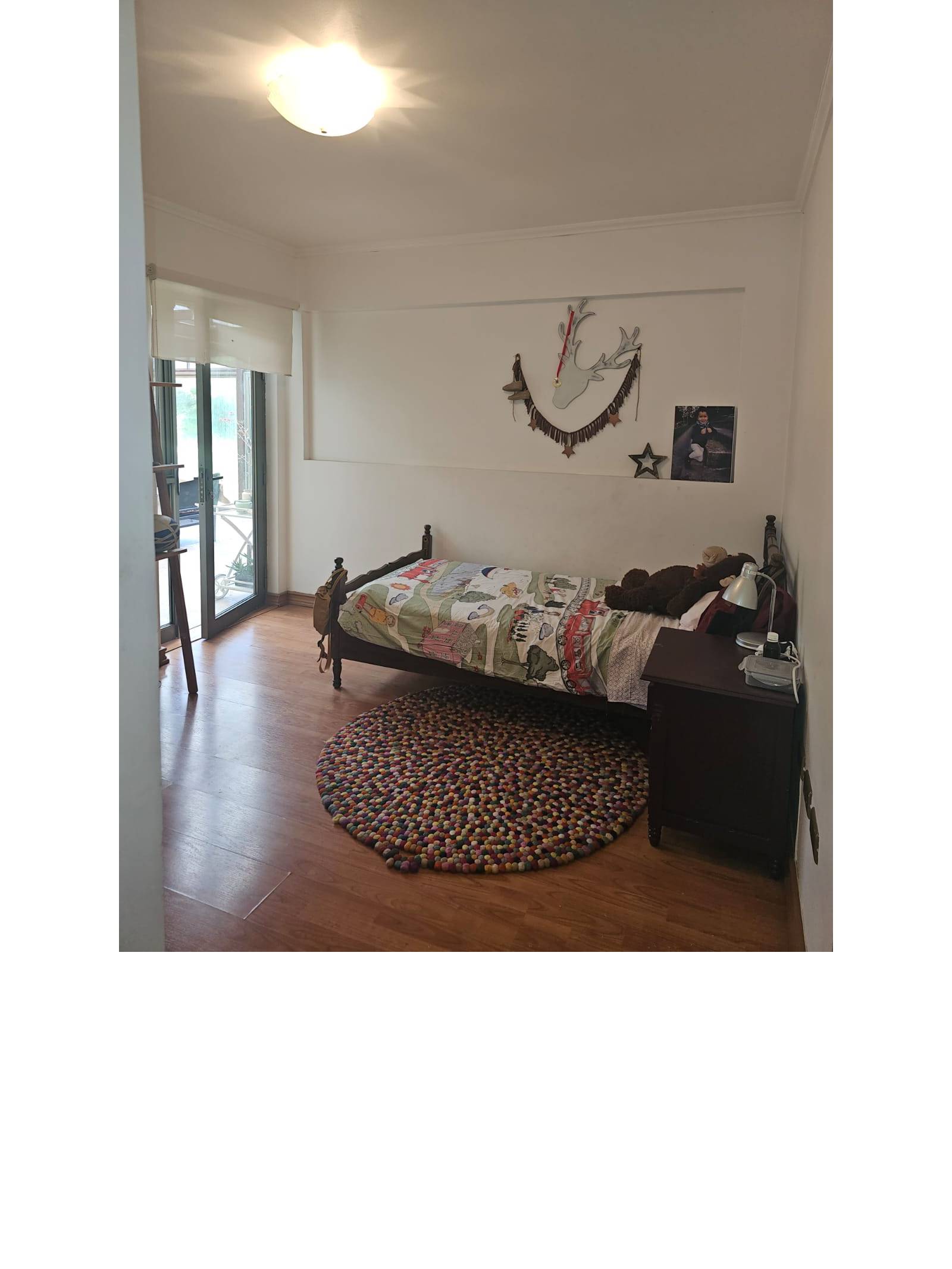 Dormitorio individual con salida al exterior mediante puerta corredera.