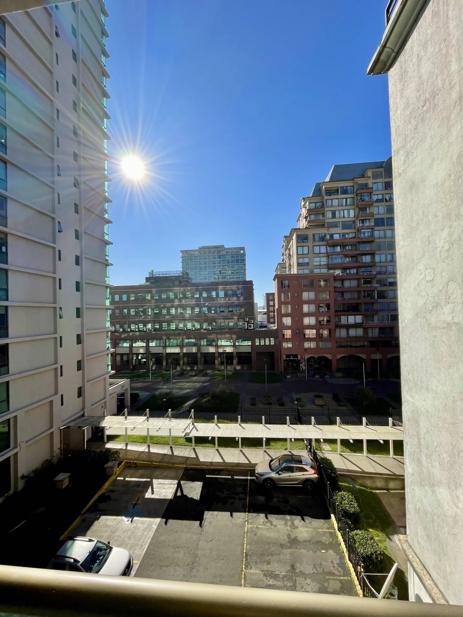 Vista despejada a la ciudad y estacionamientos en día soleado